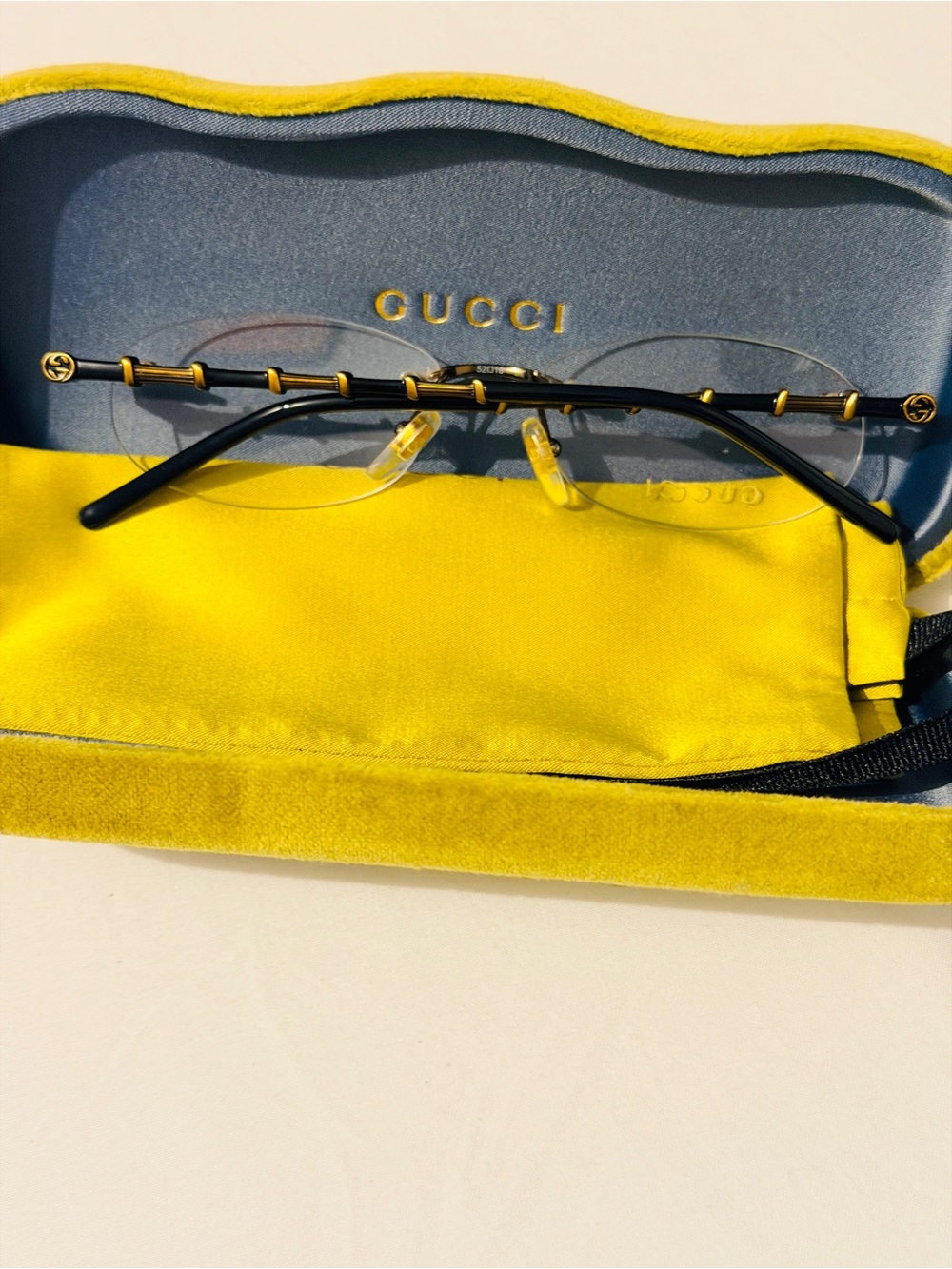 Gucci Rimless Men's Glasses in Black and Gold Accents